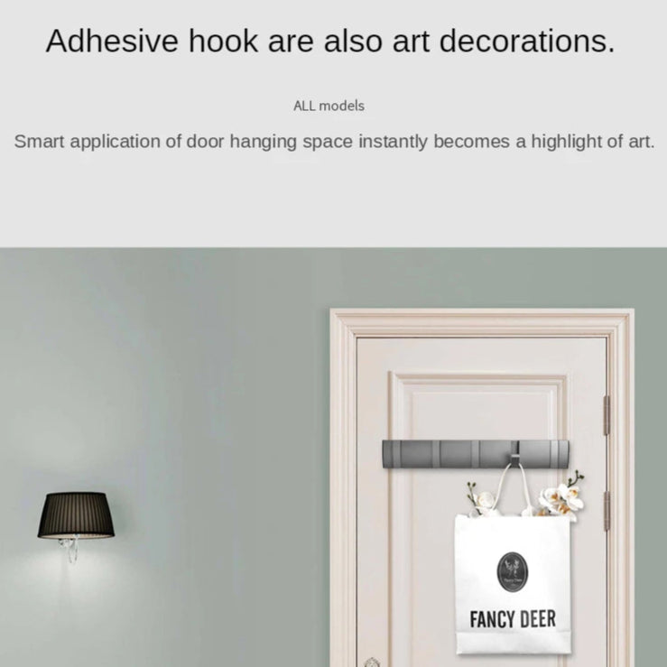 Adhesive hook used as art decoration on a door with a gray wall and chair in the background.