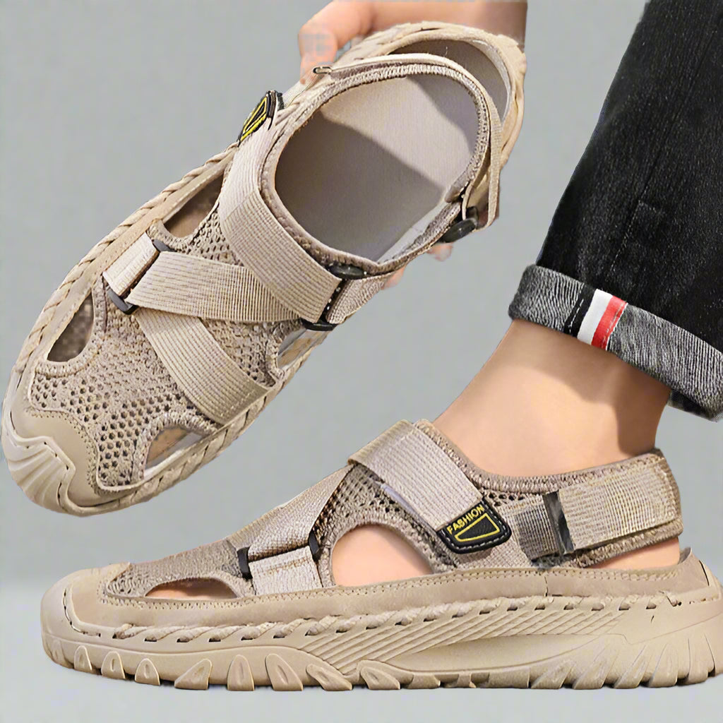 Beige sandals being worn on a blurred outdoor background
