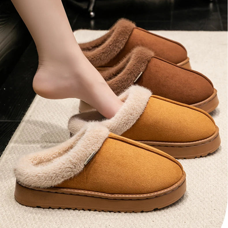 Brown warm winter slippers with fluffy lining worn by a person indoors.
