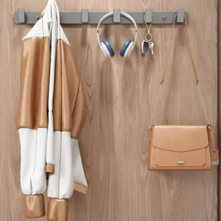 Coat, headphones, keys, and a handbag hanging on a wooden wall with hooks.