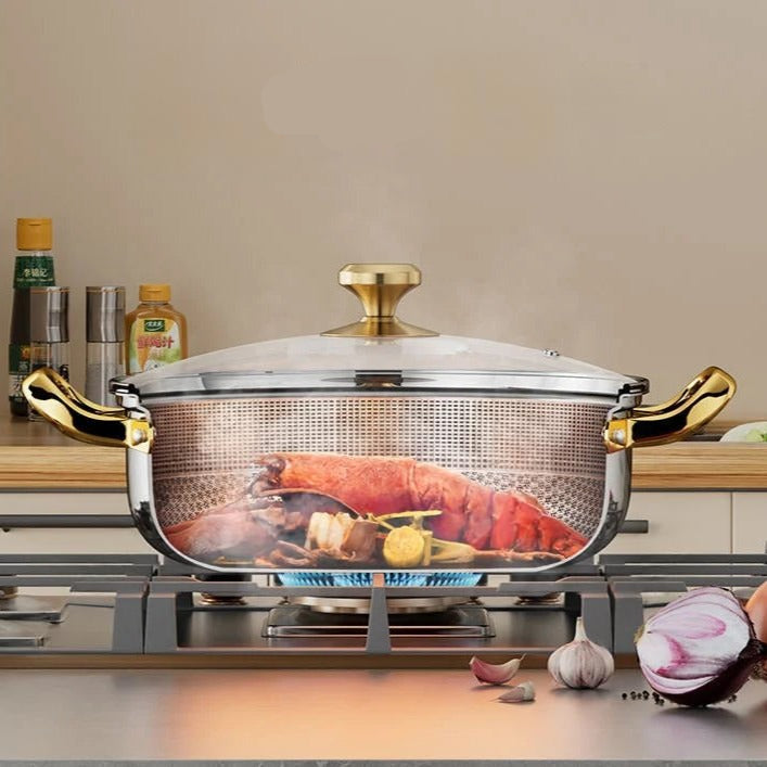 Stainless steel pot with gold handles on a stove, containing food, with 'energy reduction' text.