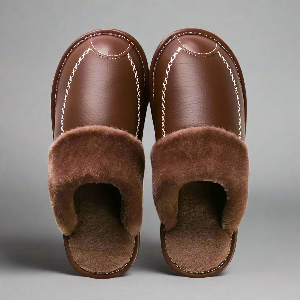 Pair of brown slippers with fuzzy lining on a white background