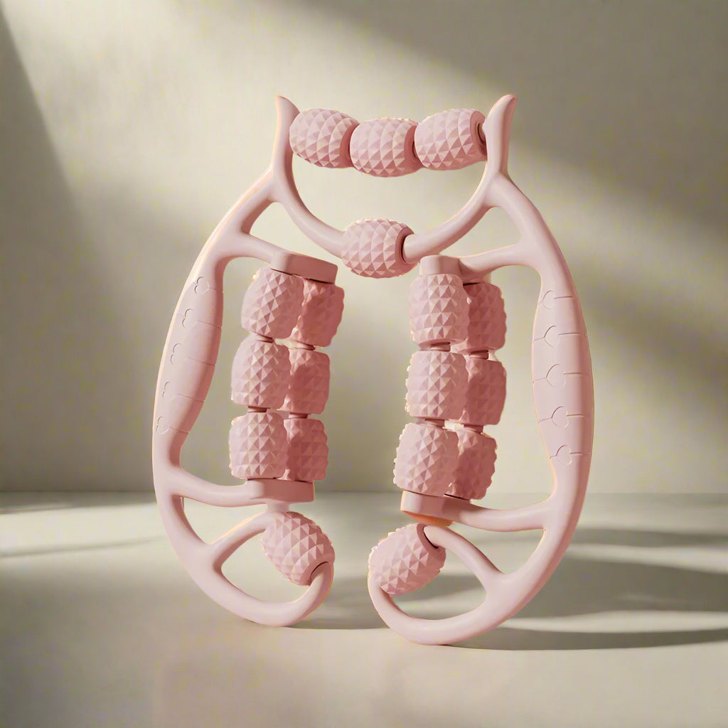 Pink massage roller with textured design on a light pink background