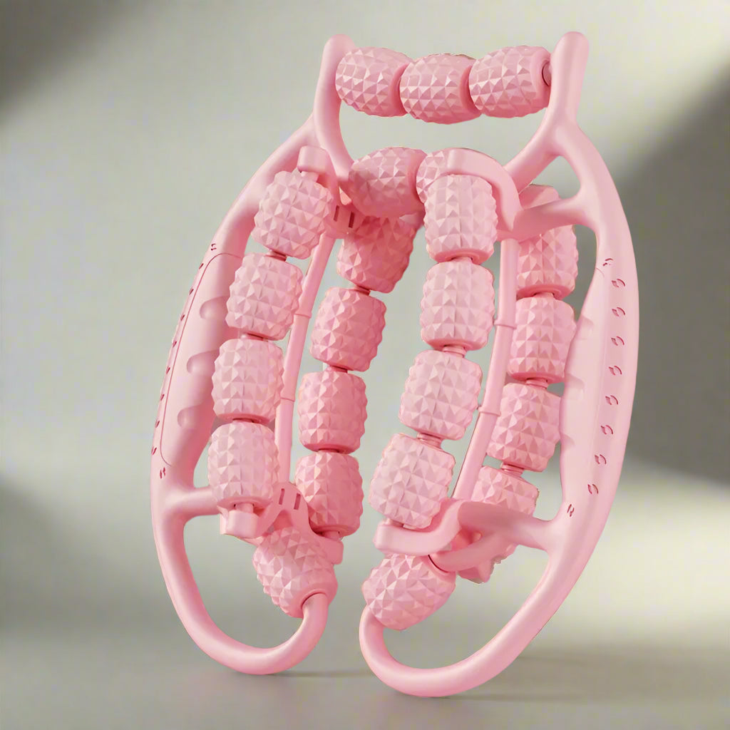 Pink massage roller with textured nodes on a pink background
