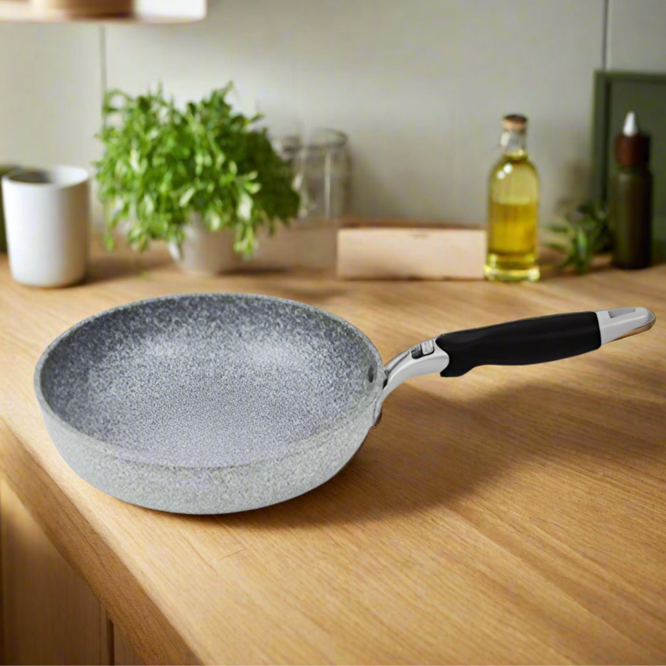 Frying pan with measurements and weight displayed on a gray background
