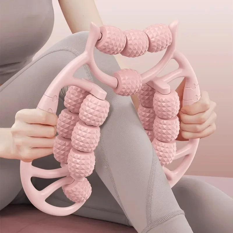 Person using a pink massage tool on their leg against a neutral background