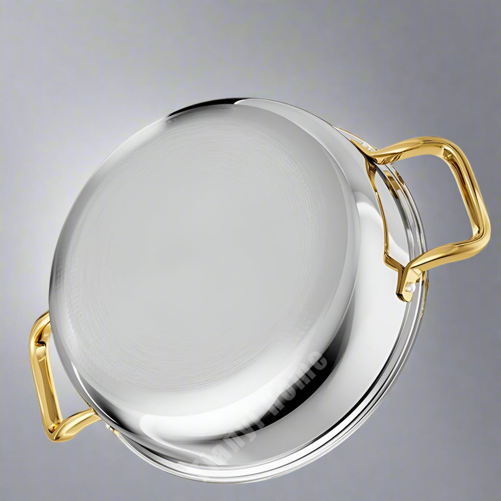Stainless steel pot with gold handles on a light gray background