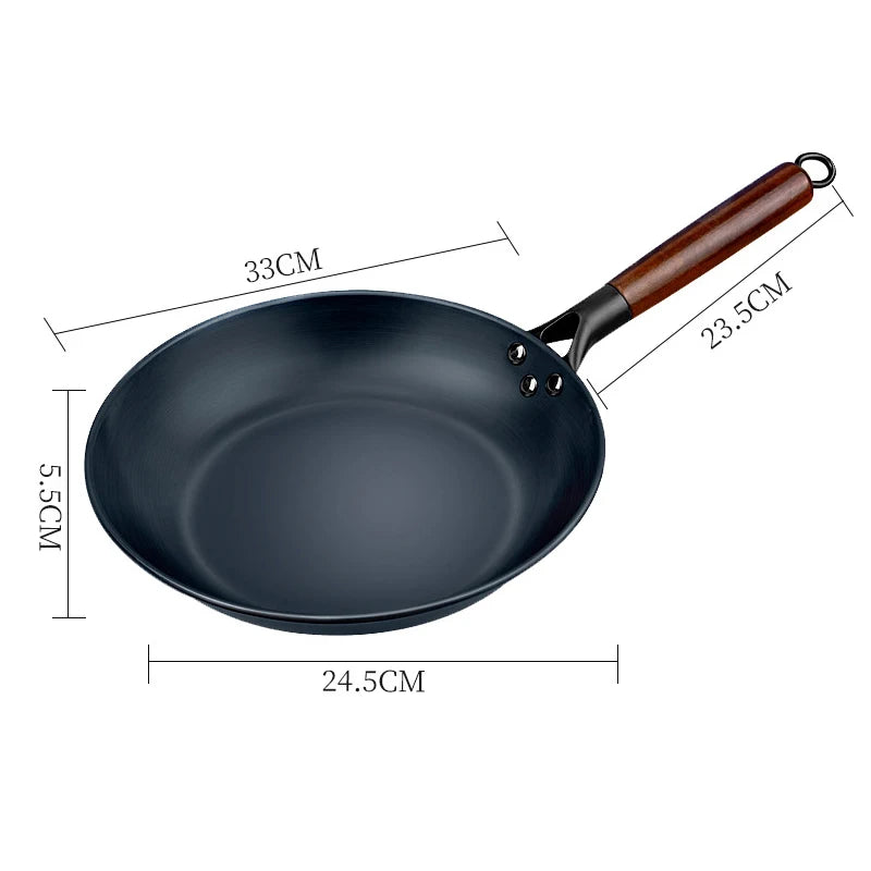 Black frying pan with wooden handle and measurements on a white background