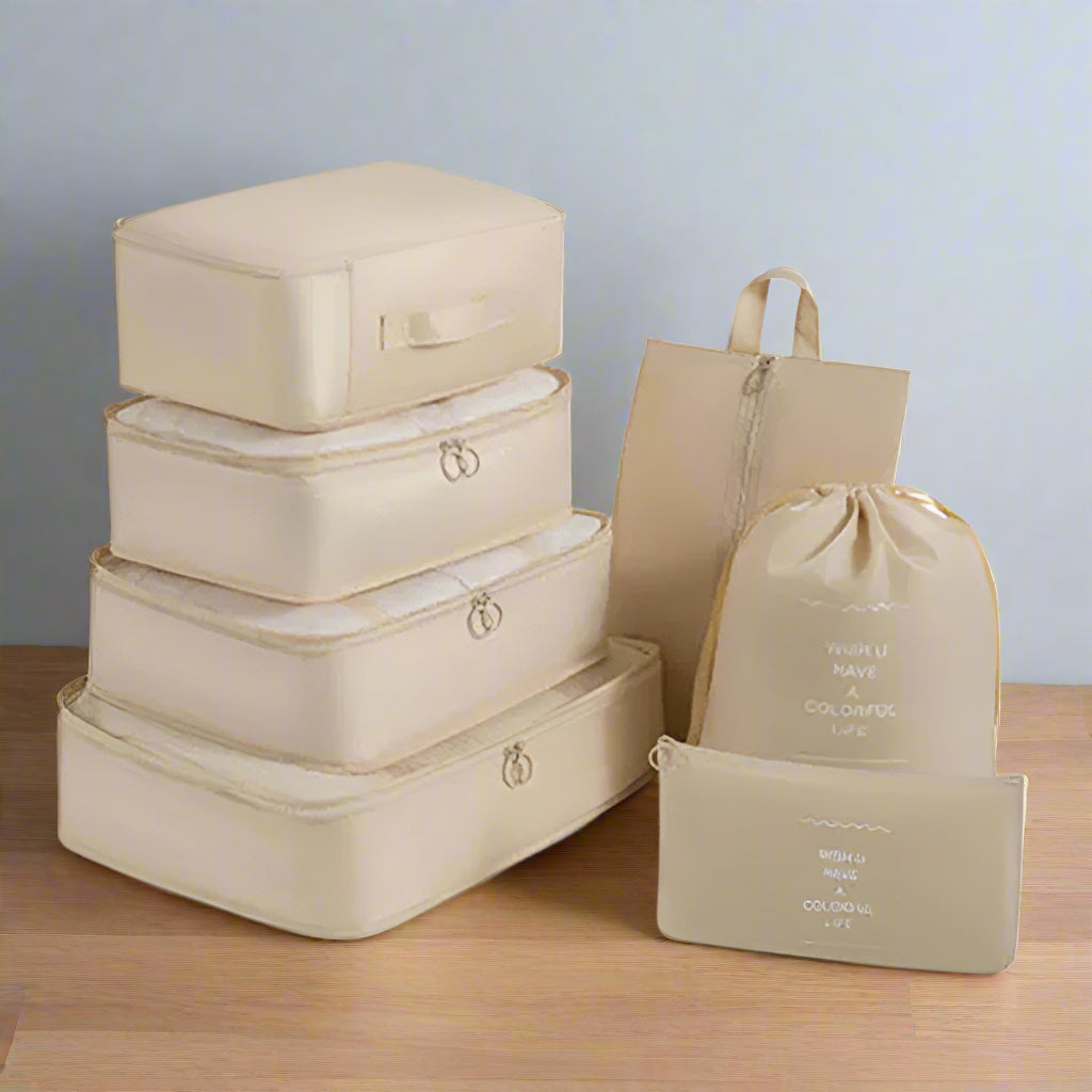 Set of beige packing cubes and bags on a white background
