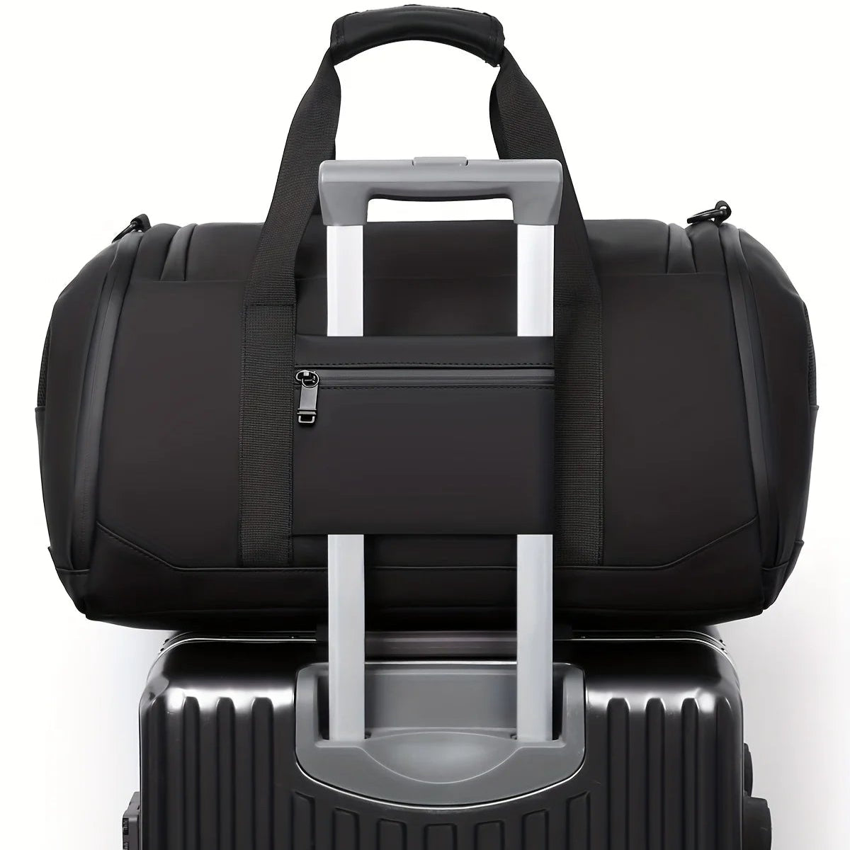 Black duffel bag with luggage trolley strap on a white background