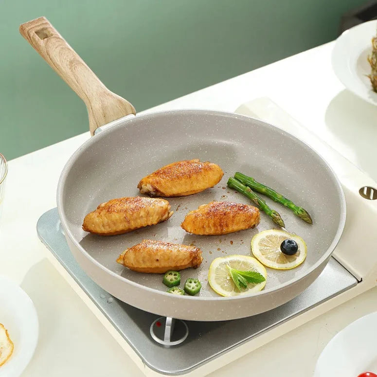 Frying pan with food on a stove against a green background