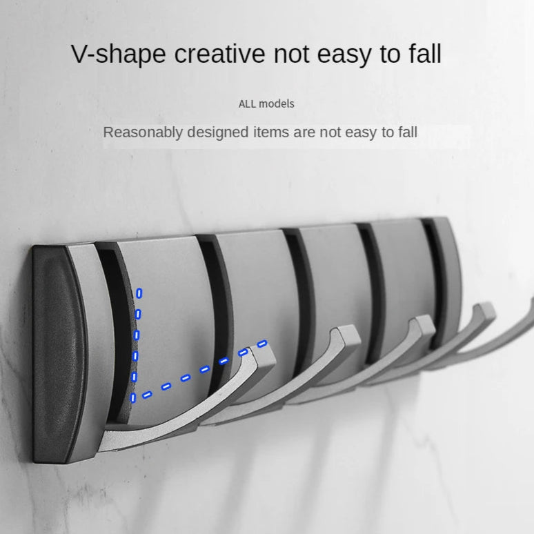 Wall-mounted coat rack with five hooks on a light gray background