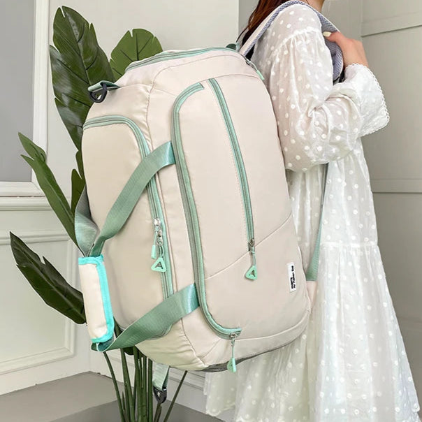 Woman holding a beige backpack with green accents in a minimalistic indoor setting