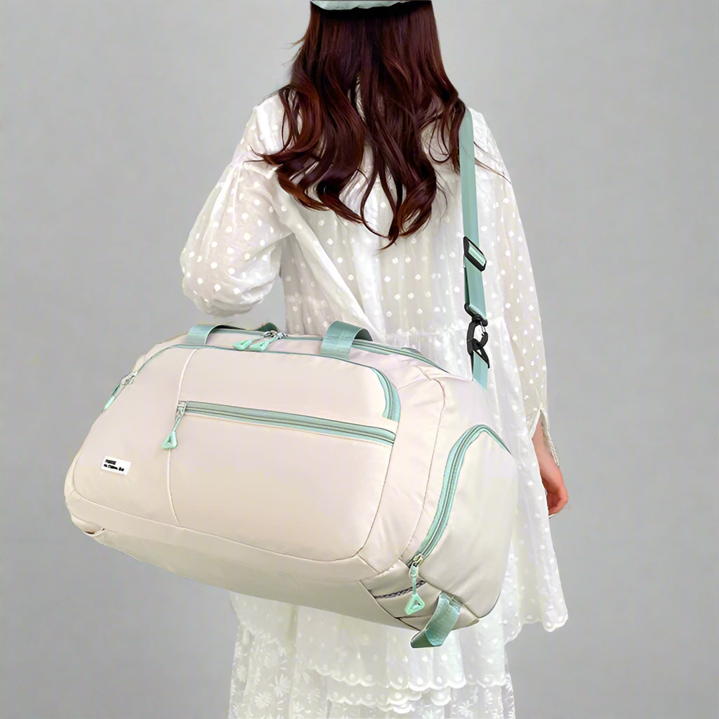 Woman holding a beige travel bag with 'Perfect Lady' branding in a minimalistic setting.