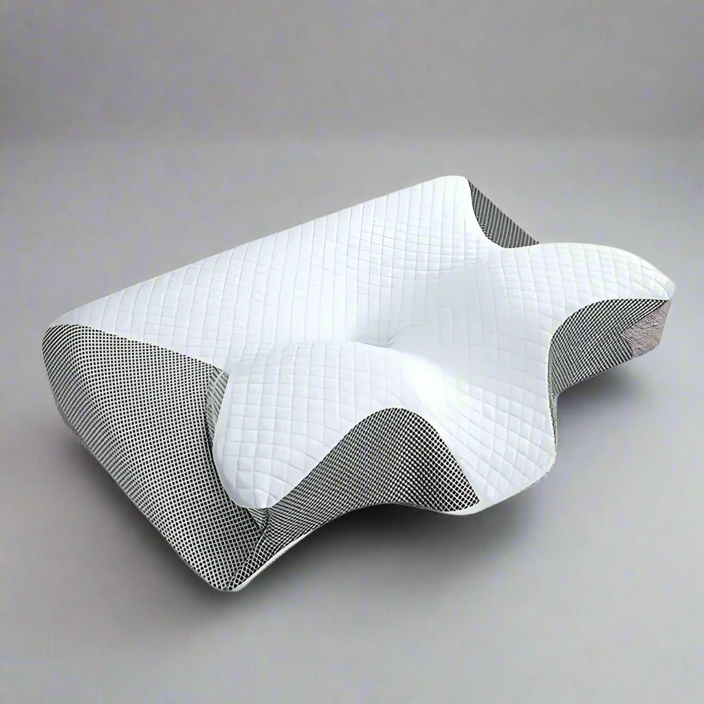 An ergonomic memory foam pillow with a contoured design, displayed in different settings showing its use for neck support and as a sleeping pillow.