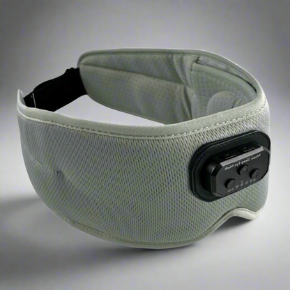 A blue Bluetooth sleep mask with integrated headphones and a control panel, designed to block light and provide white noise or music for relaxation.