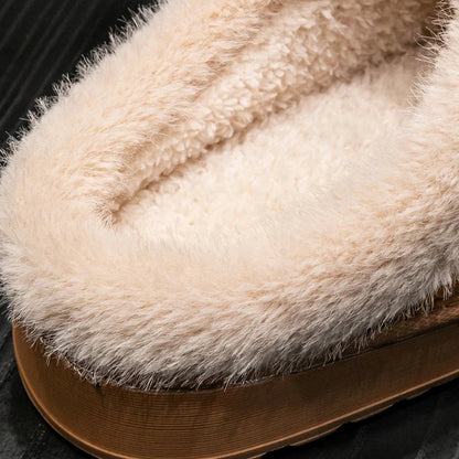 Close-up of a fluffy beige slipper on a dark background