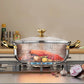 Stainless steel pot with gold handles on a stove, containing food, with 'energy reduction' text.