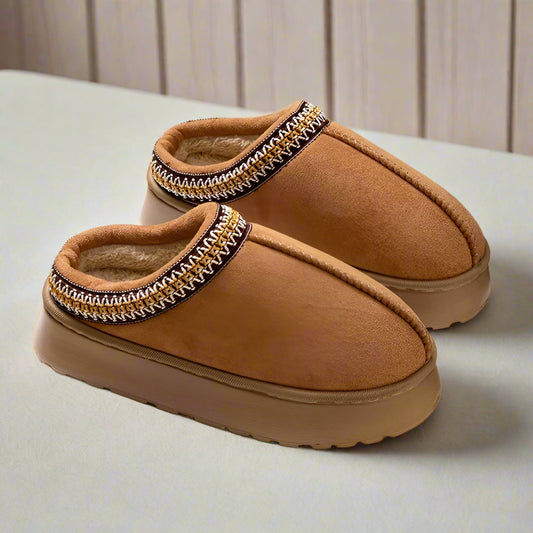 Pair of brown Embroidered Winter Home Slippers – Where Warmth Meets Style
 with decorative trim on a white surface.