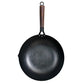 Black wok with a wooden handle on a white background