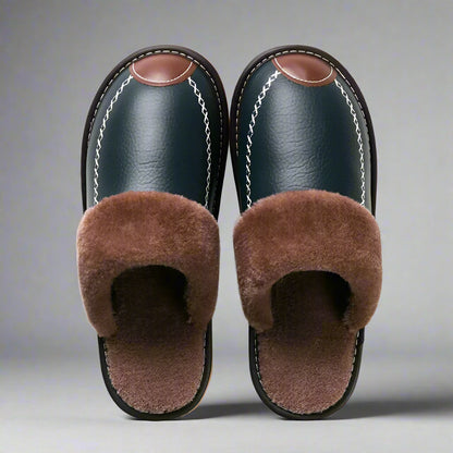 Pair of black slippers with brown fur on a white background
