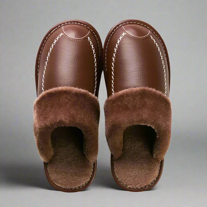 Pair of brown slippers with fuzzy lining on a white background