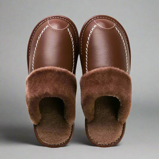 Pair of brown slippers with fuzzy lining on a white background