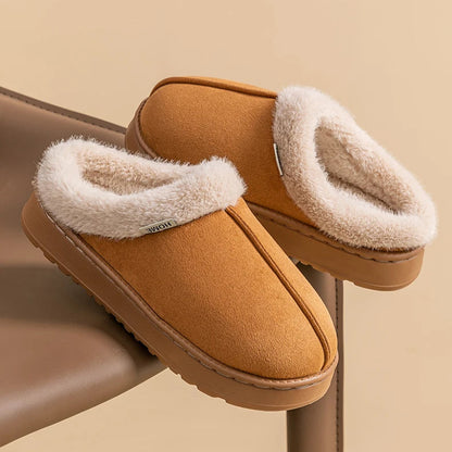 Pair of brown slippers with white fur lining on a beige background