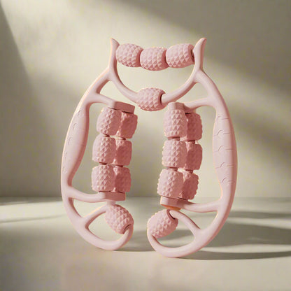 Pink massage roller with textured design on a light pink background