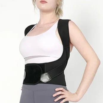 Person wearing a black posture corrector on a white background