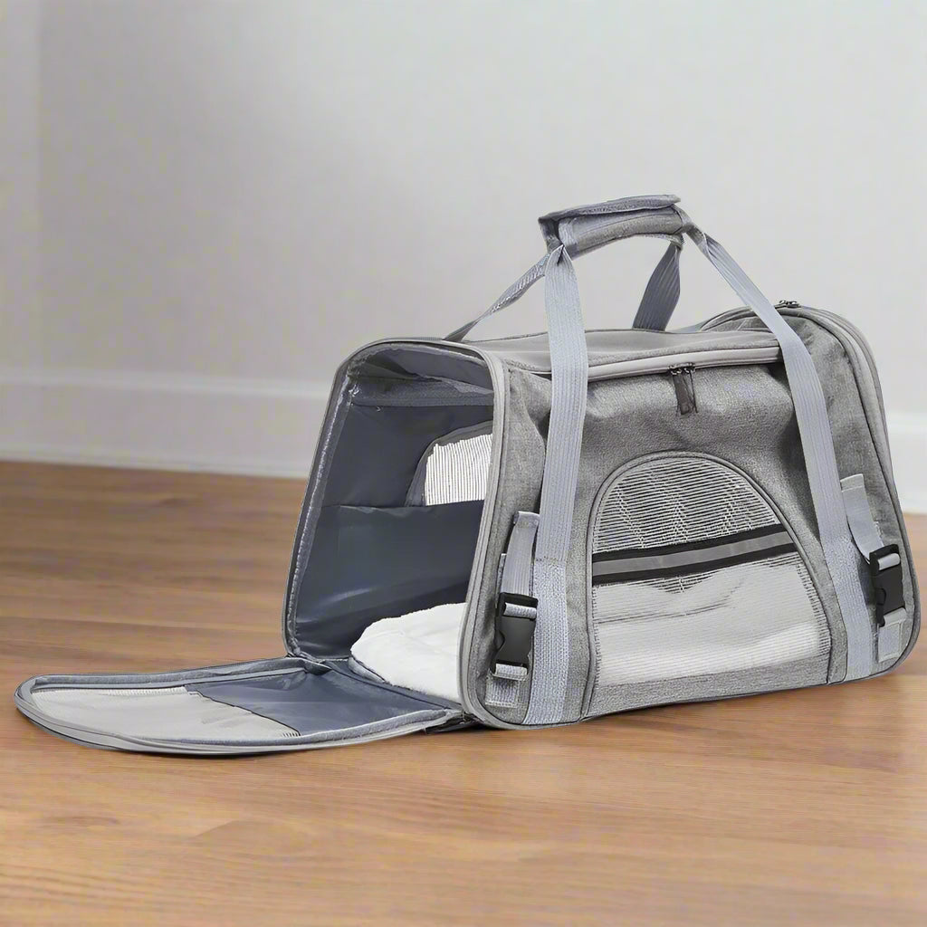 Gray pet carrier with open lid on a white background