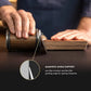 Person using a wooden tool with a magnetic angle support on a dark surface.