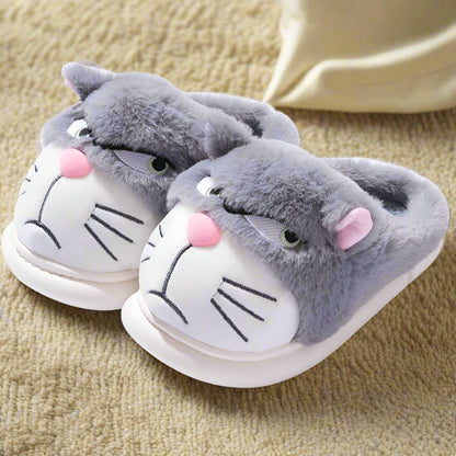 Pair of gray cat-shaped slippers with pink accents on a white background