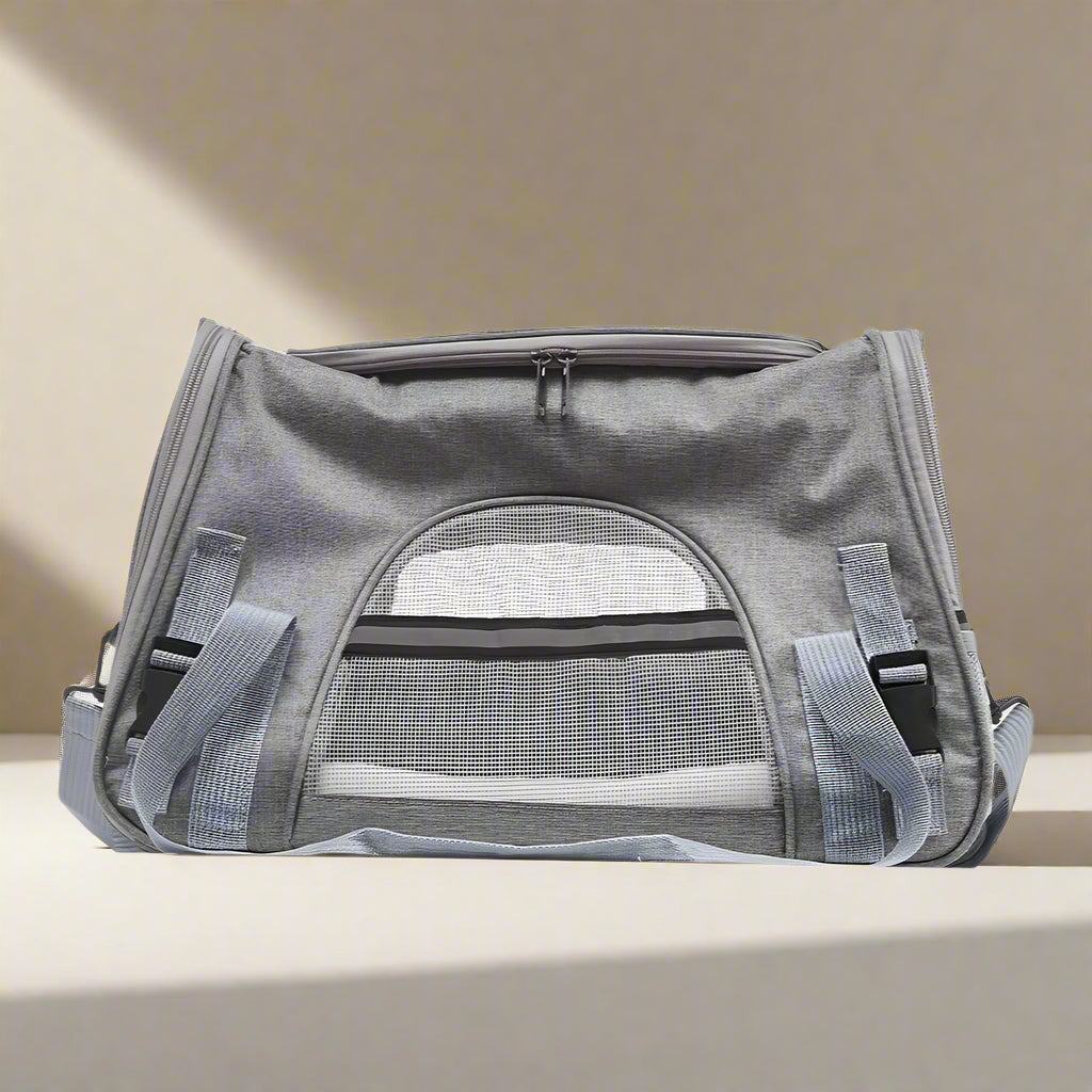 Gray pet carrier with mesh window on a white background