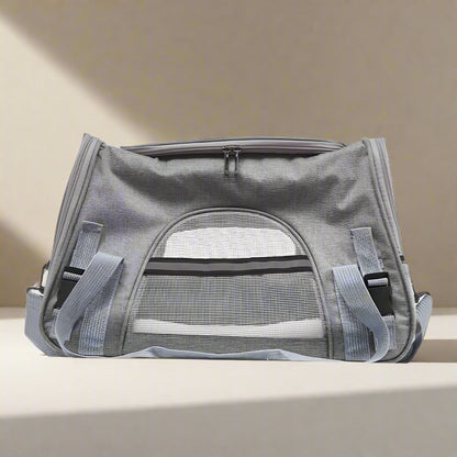 Gray pet carrier with mesh window on a white background