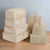 Set of beige packing cubes and bags on a white background