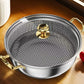 Metallic pan with a textured surface and gold handles on a wooden surface