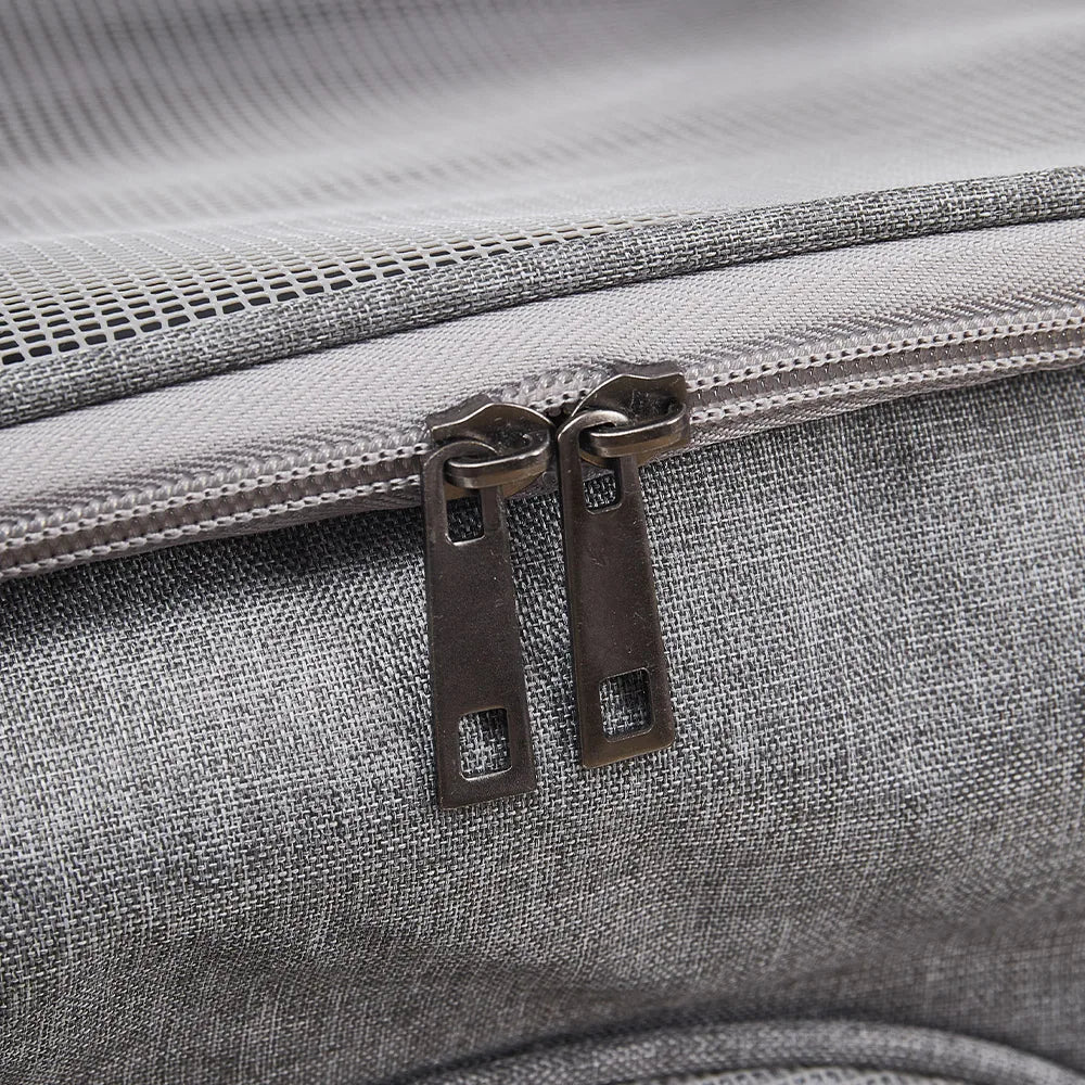 Close-up of a gray textured bag with a zipper and metal pull.