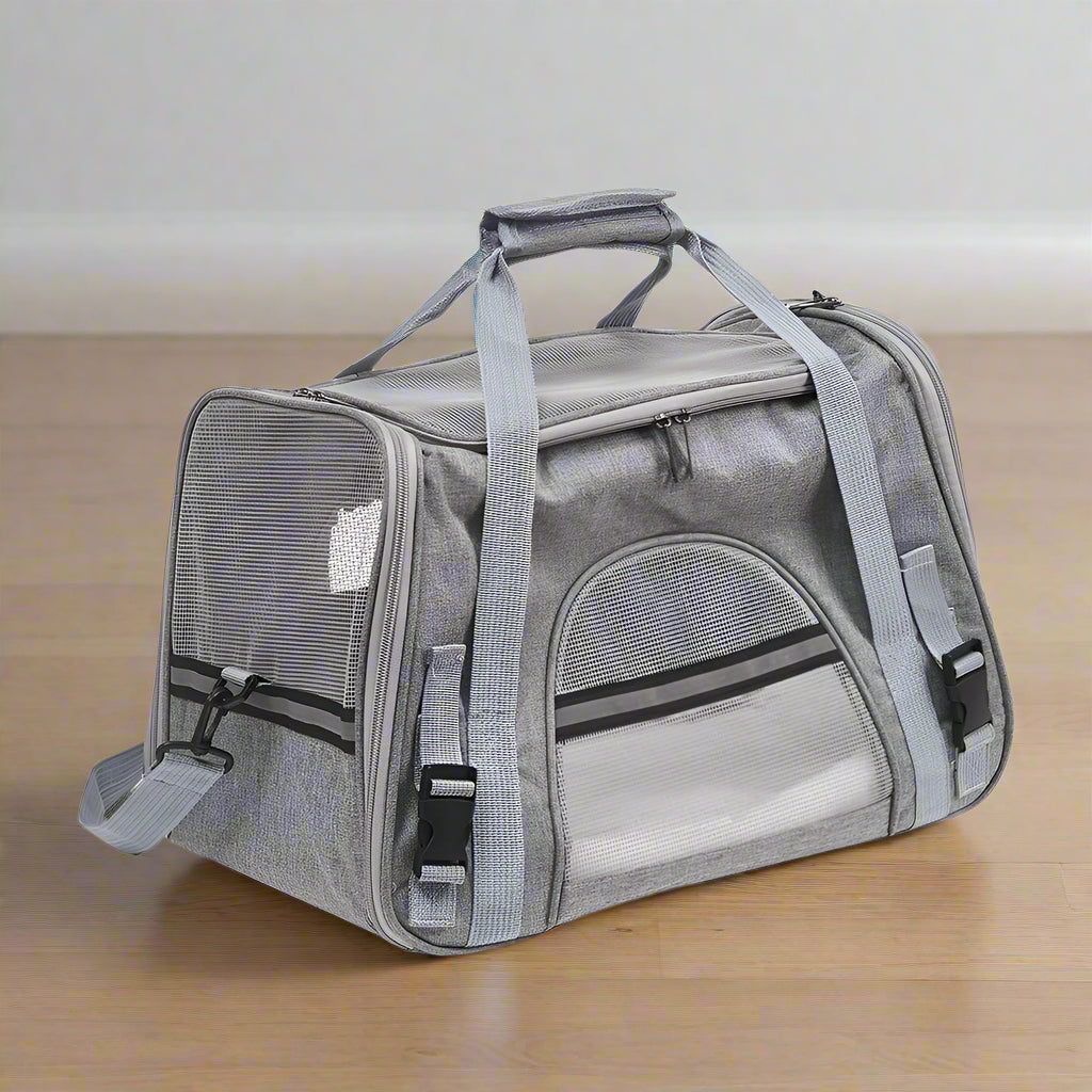 Gray pet carrier with mesh sides on a white background