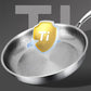 Stainless steel frying pan with a gold 'Ti' badge on a dark background