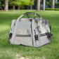Gray pet carrier on grass with trees in the background