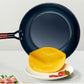 Blue frying pan with a yellow tortilla on a white plate against a light gray background