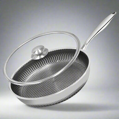 Stainless steel frying pan with lid on a white background