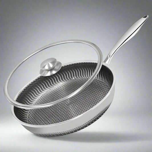 Stainless steel frying pan with lid on a white background