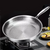 Titanium hammered frying pan on a stove with text highlighting benefits