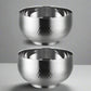 Two silver metallic bowls with a textured surface on a white background
