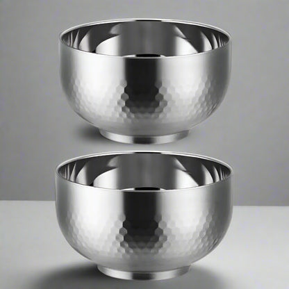 Two silver metallic bowls with a textured surface on a white background