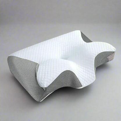 An ergonomic memory foam pillow with a contoured design, displayed in different settings showing its use for neck support and as a sleeping pillow.